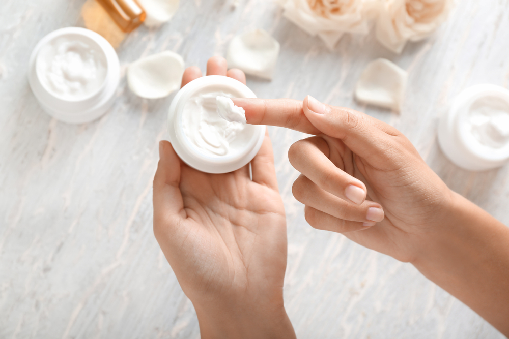 Woman's Hands Applying Body Cream