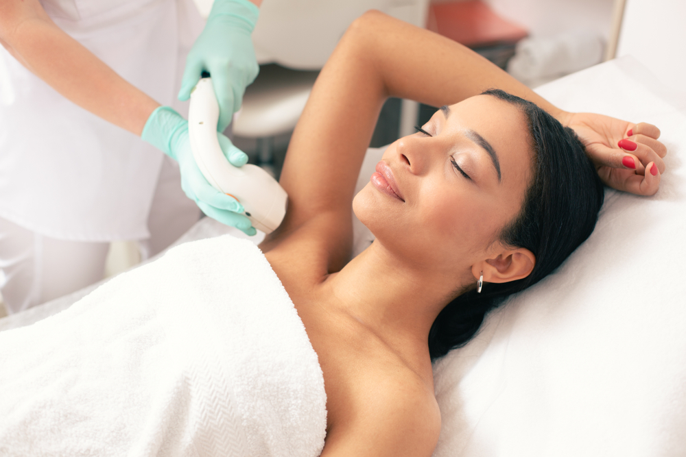 Calm Young Woman Lying With Closed Eyes in Treatment Room