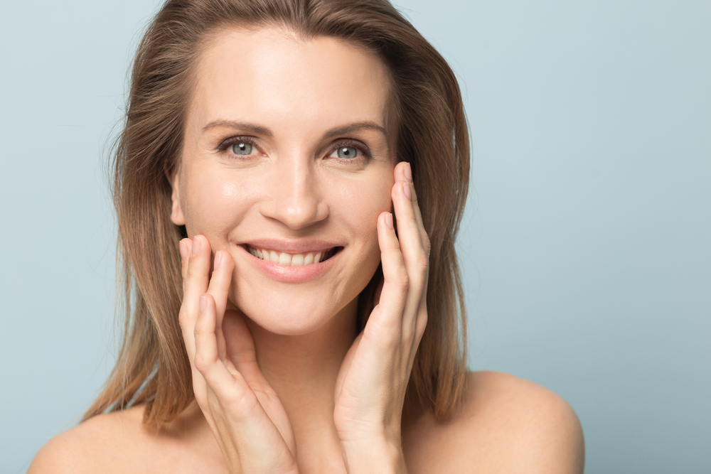 Head Shot Portrait Smiling Woman Touching Perfect Smooth Face Skin