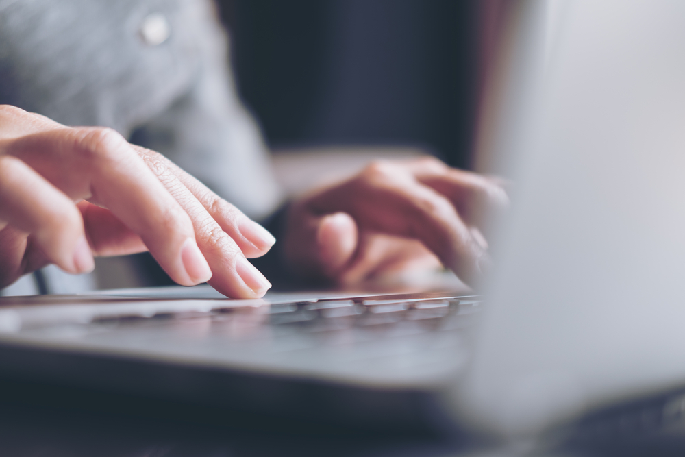 Business Woman's Hands Working And Typing