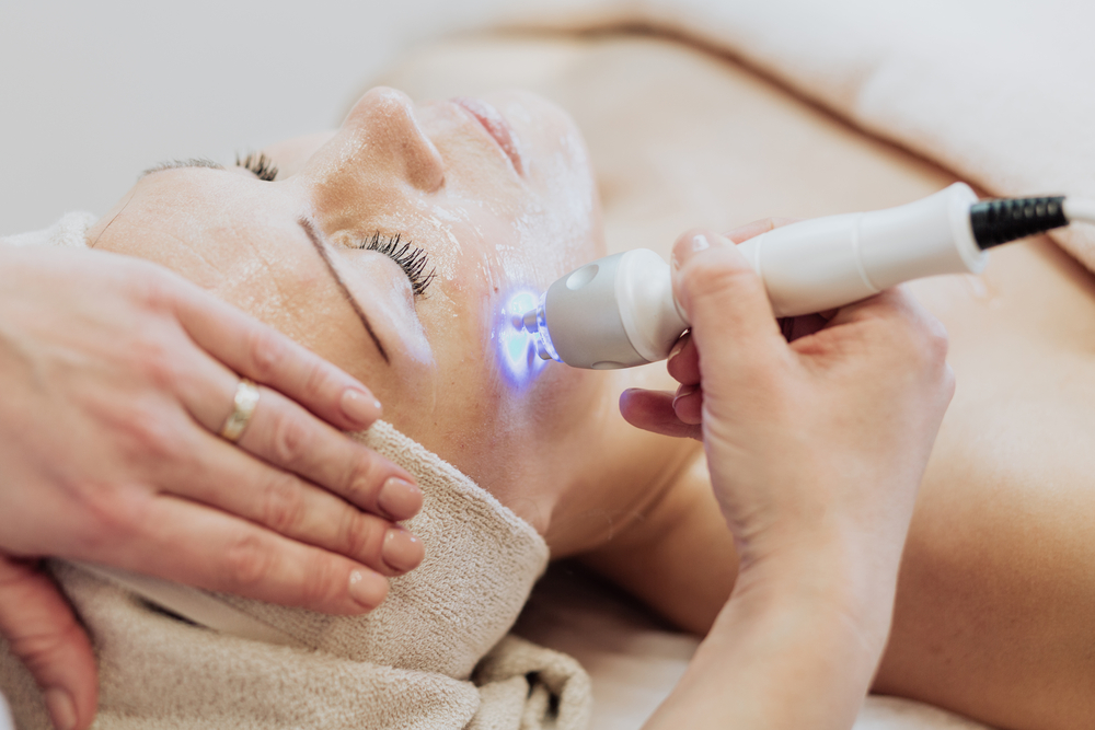 Woman Getting Laser And Ultrasound Face Treatment In Medical Spa